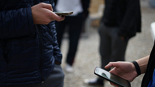 Two people scrolling through their phones