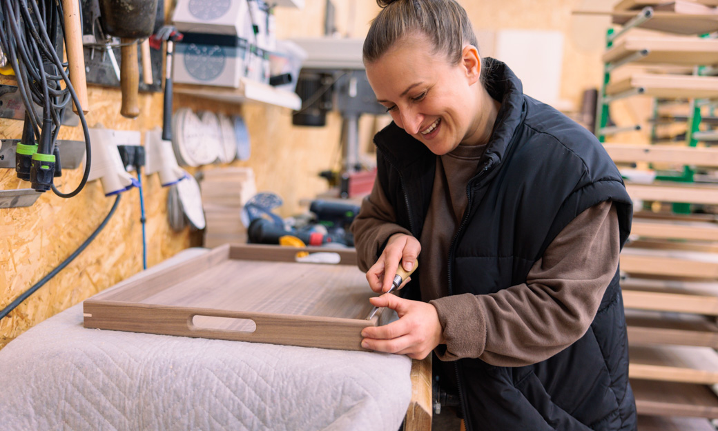 Monika in her workshop, creating a wooden tray
