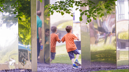 Child plays in maze of mirrors