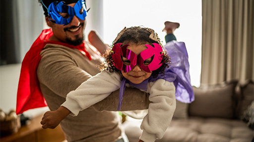 Father and daughter dressed as superheroes