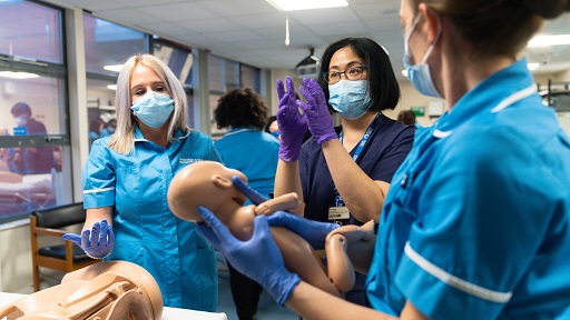 Tutor explaining midwifery practises to students