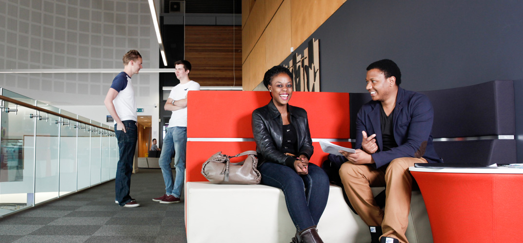 Smiling students in a learning space