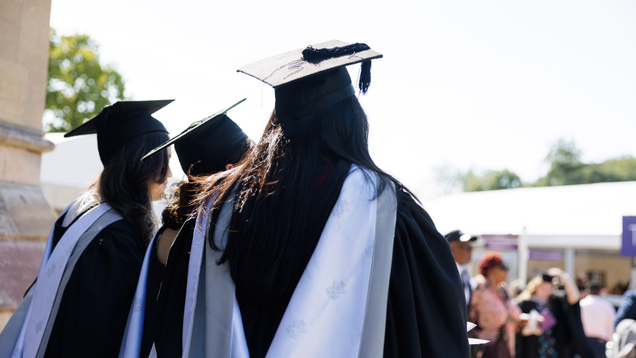 graduates with gown