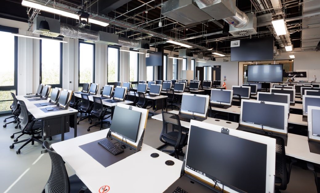 A classroom filled with computers in Spectra